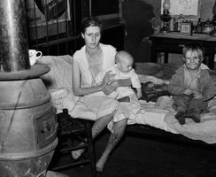 The wife and two children of an unemployed mine worker living in an old company store in an abandoned mining town